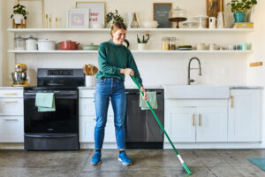 housekeeper sweeping kitchen