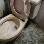 Dirty toilet bowl with hard water stains buildup