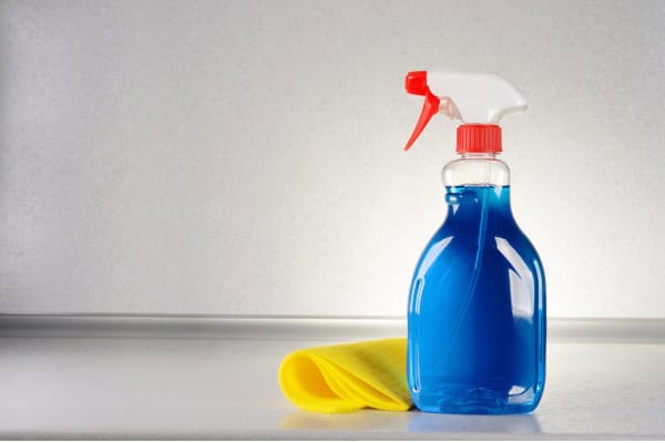 close-up of glass cleaner with yellow cloth