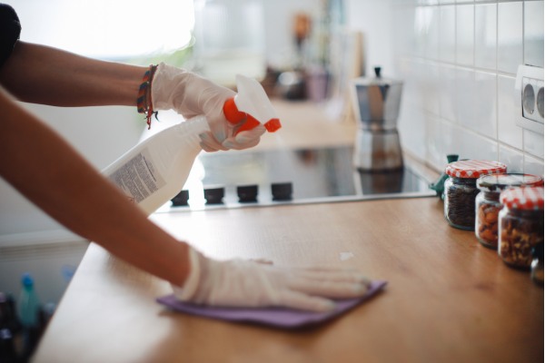 Woman is cleaning her kitchen counter