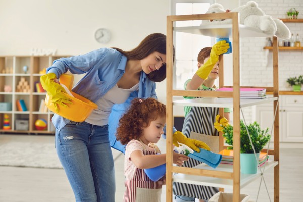 Happy family cleans up shelf with gloves. 