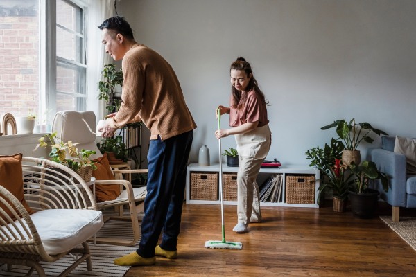 a couple cleaning their living room